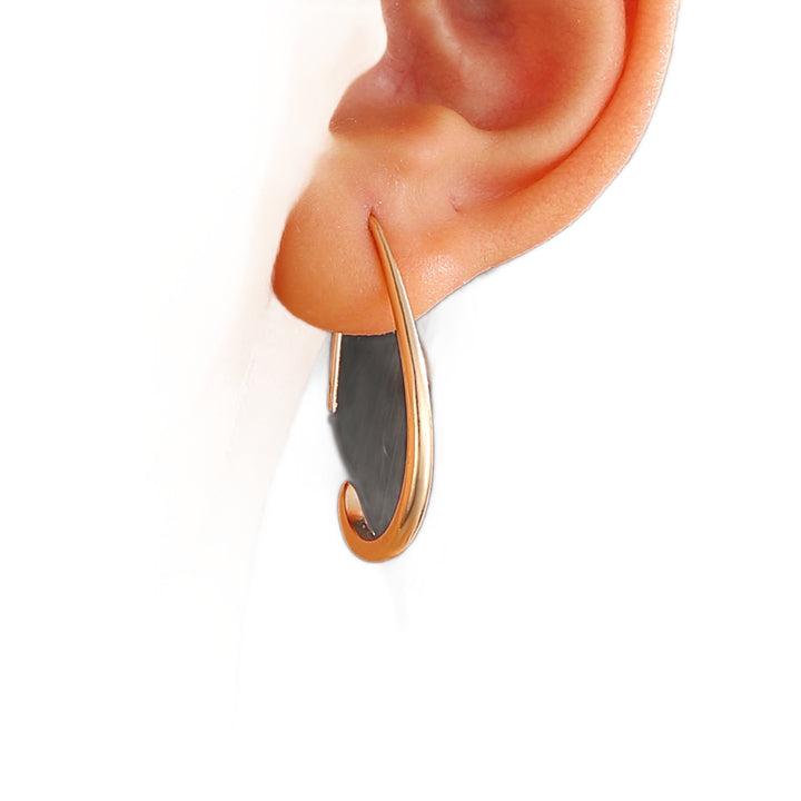 Close-up of the gold-tone teardrop hoop on the ear