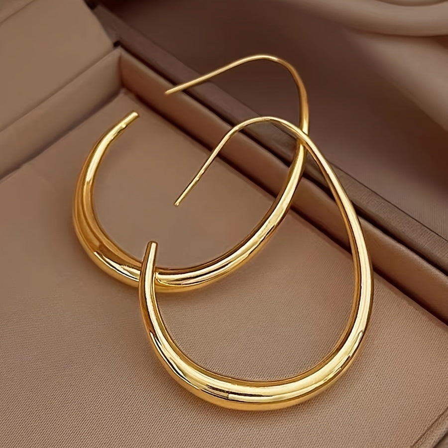 Pair of gold-tone teardrop hoops in a jewellery box