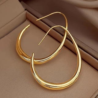 Pair of gold-tone teardrop hoops in a jewellery box