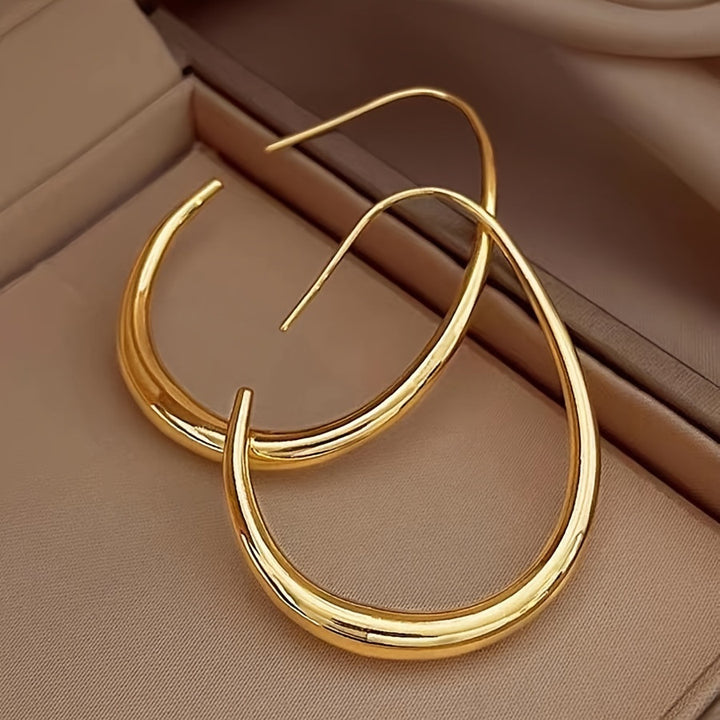 Pair of gold-tone teardrop hoops in a jewellery box