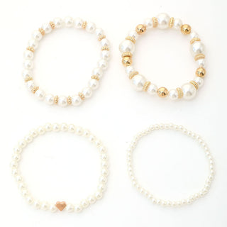 The four bracelets of the Layered Pearl Bracelet Set laid out side by side