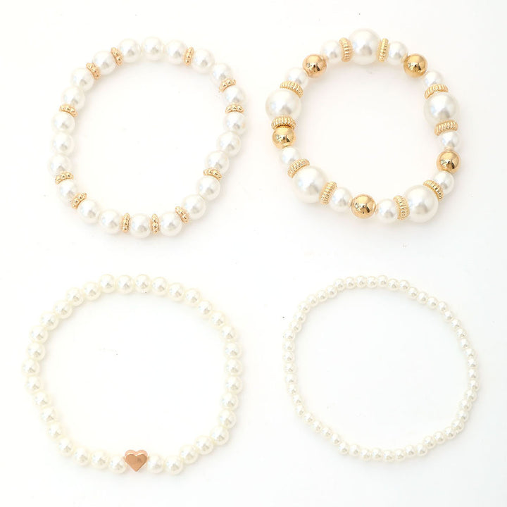 The four bracelets of the Layered Pearl Bracelet Set laid out side by side